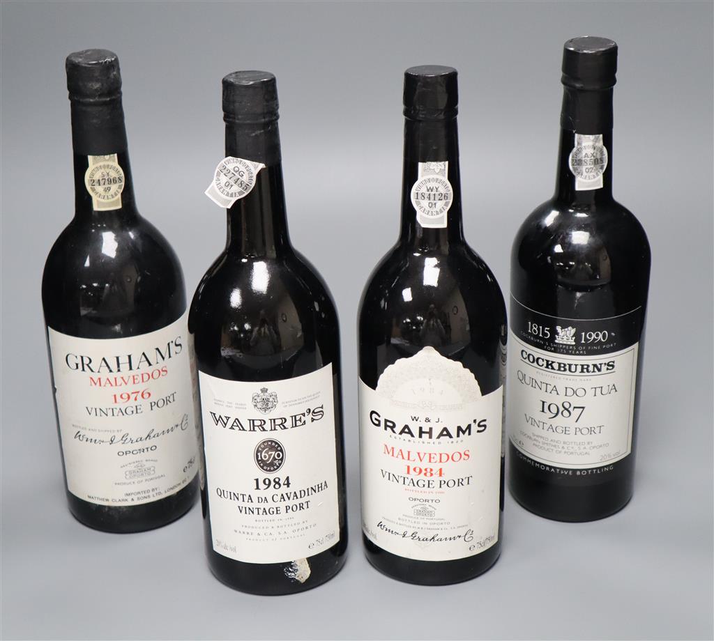 Four bottles of vintage port; two Grahams Malvedos 1976 and 1984, one Warres Quinta da Cavadinha 1984 and one Cockburns Quinta do Tua